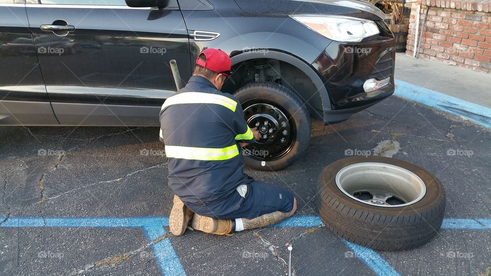 Mechanic fixing flat tire