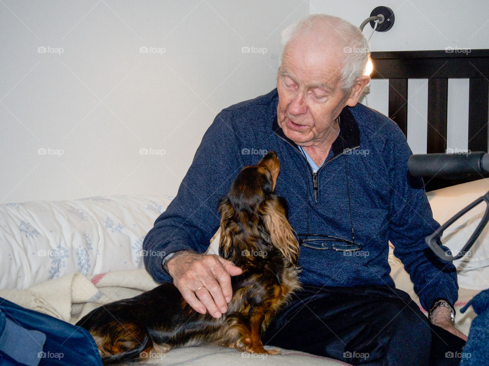 Senior man playing with dog