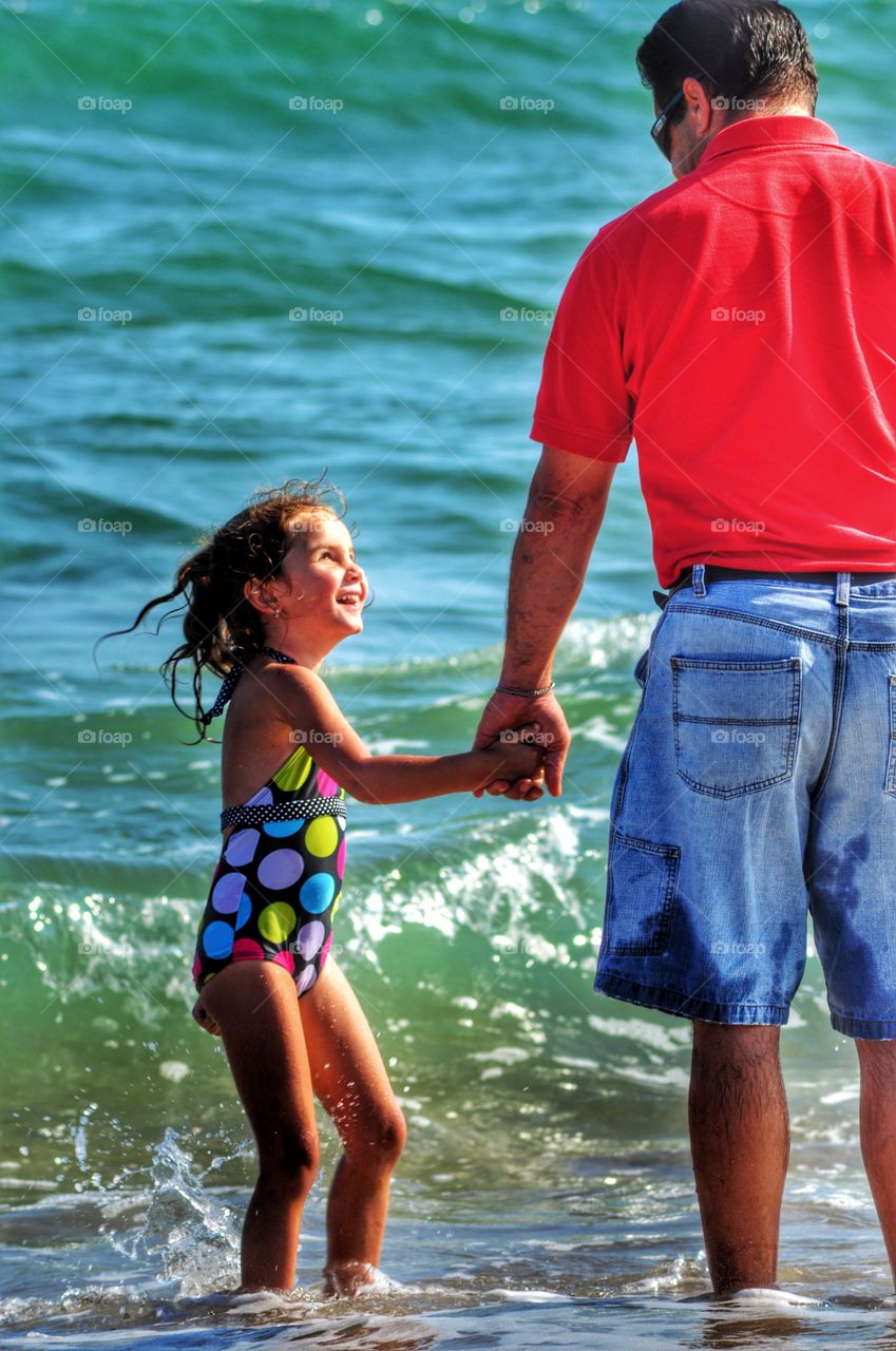 Father and daughter in sea