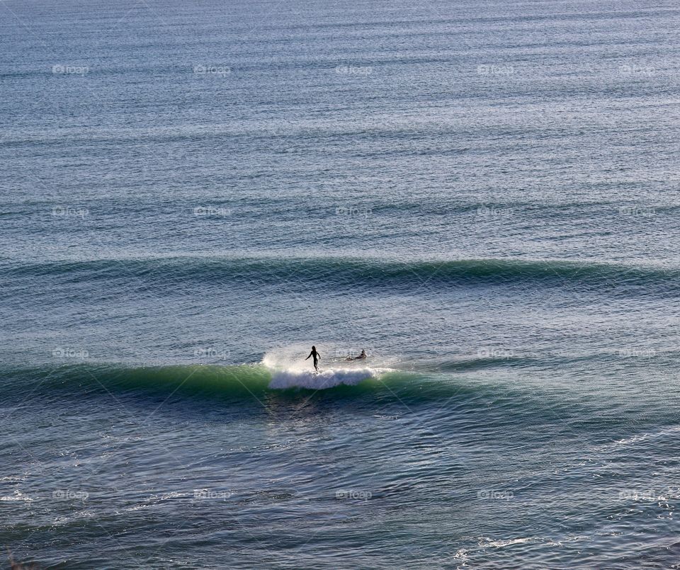 Surfers in South Australia, view from a cliff looking over the ocean, Great Australian Bight, concept travel and tourism, vacations, water sports, daredevils, freedom, minimalism, copy and text space 