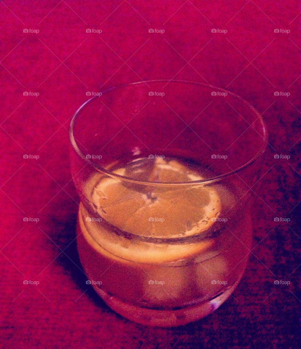 Have a drink. A slice of orange with disarrono on the rocks