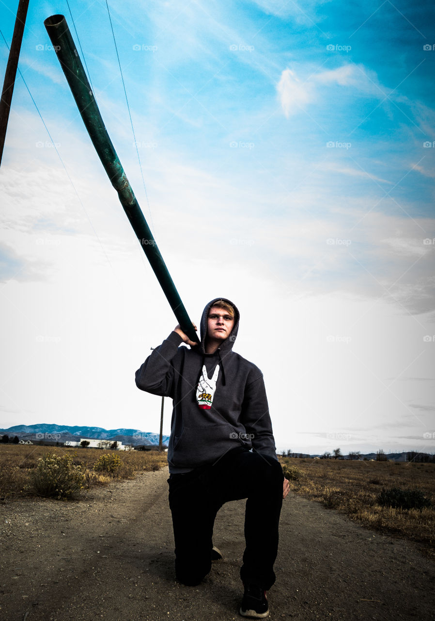 man holding a pole in a field