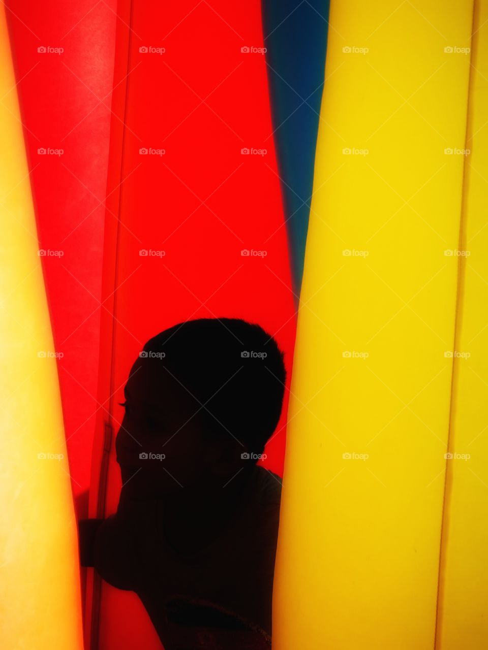 The boy between curtains of colors