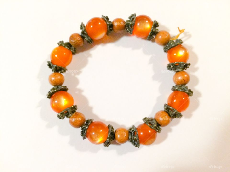Marbled orange beaded bracelet with metal spacers 
