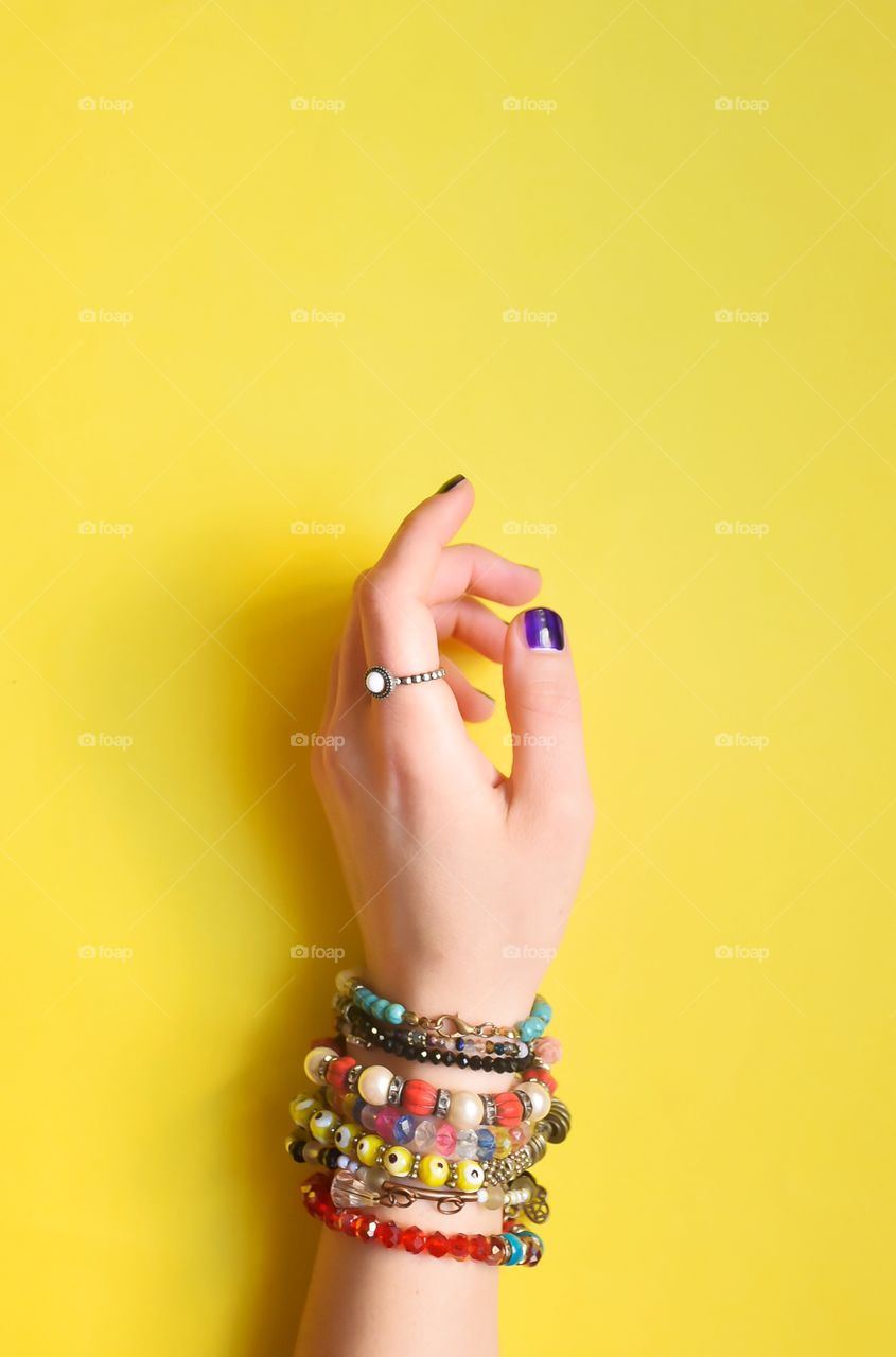 hands accesory on a yellow background