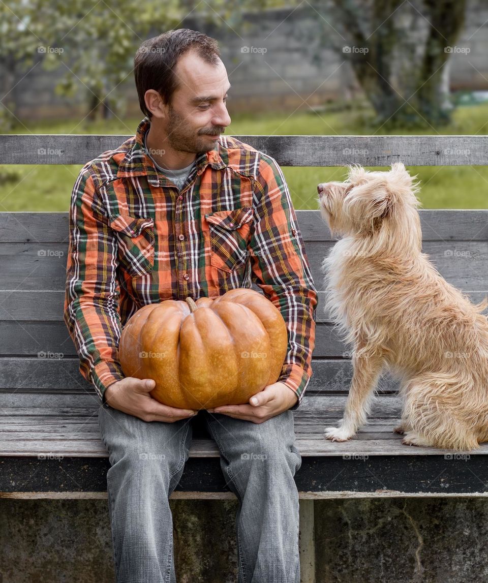 A man, a dog and a pumpkin