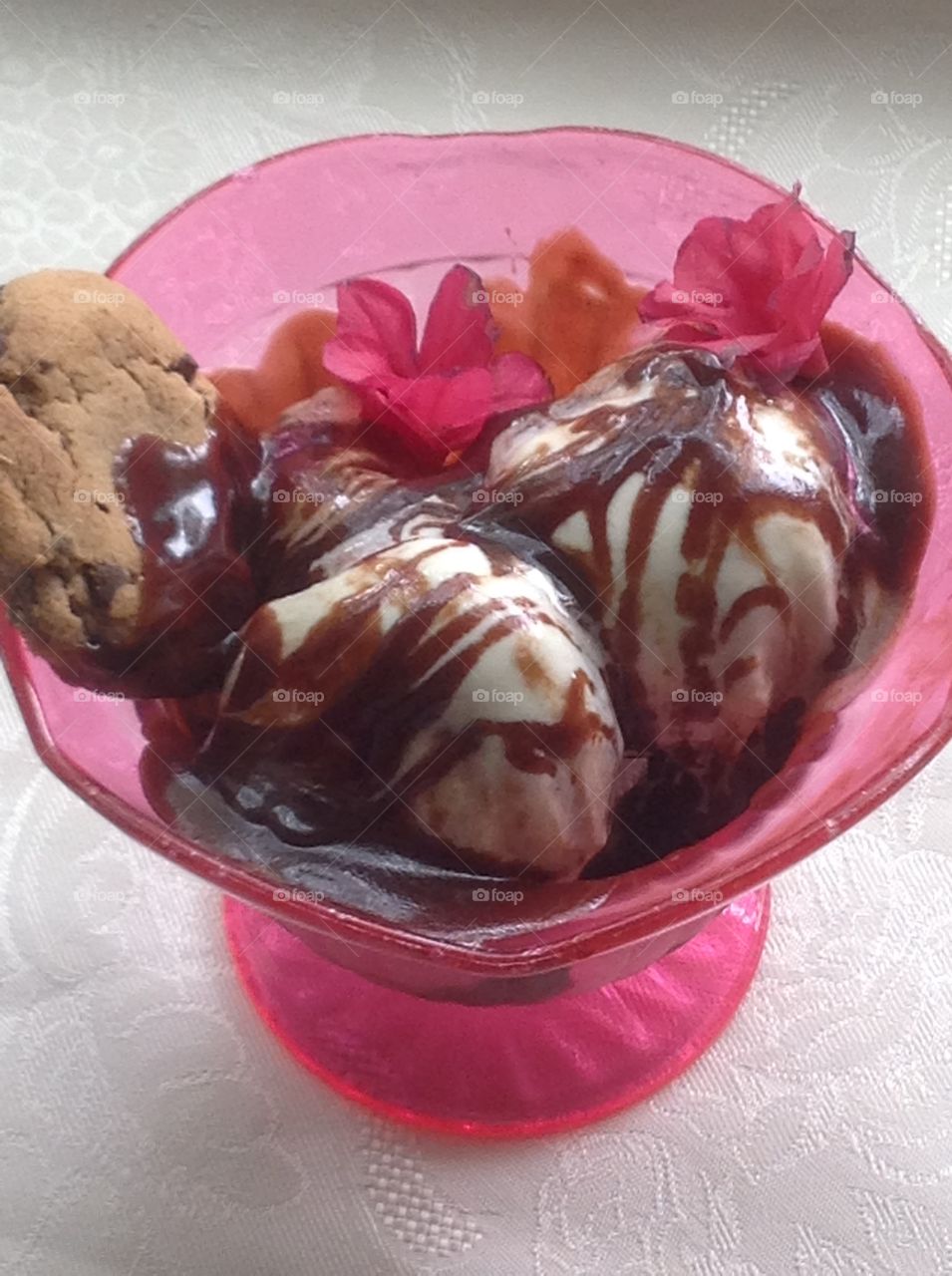 Vanilla ice cream with chocolate syrup drizzled on top.