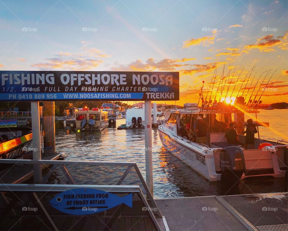 Noosa fishing boat on the river at sunset 