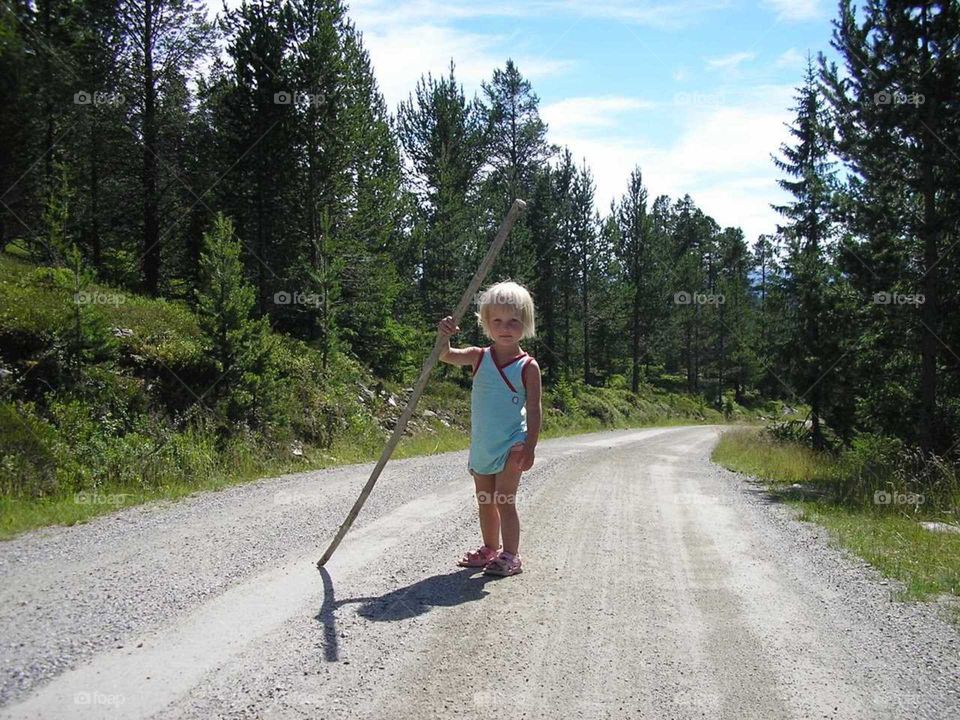 girl with stick in the Norwegian mountains
