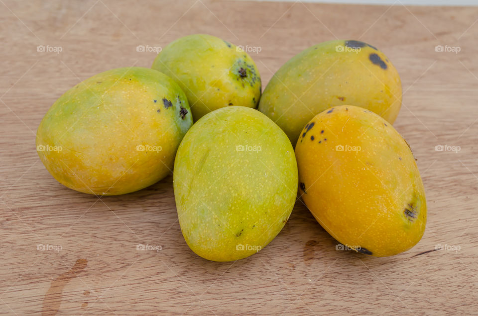 Greenskin Mangoes On Wooden Table