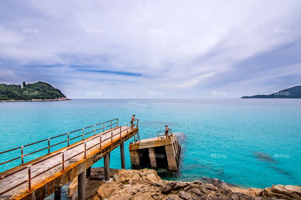Blue sea and a broken pier. A beautiful quite spot known as the Broken Pier on the smaller of the Perhentian Islands , Malaysia. 