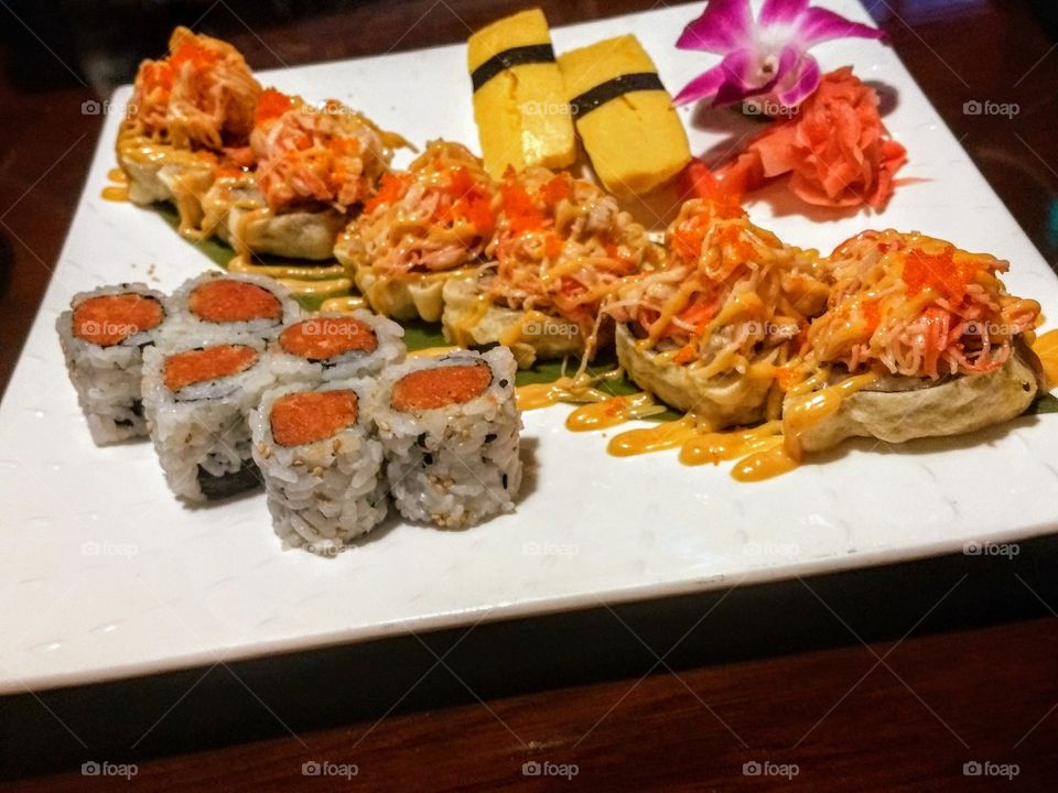colorful delicious plate of sushi on wooden table at Japanese restaurant