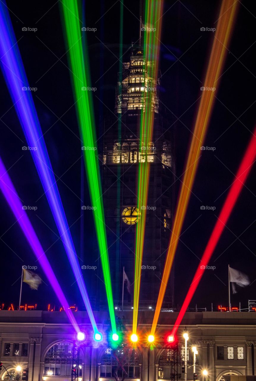 San Francisco Pride 2023 laser light display of the pride flag colors illuminating the sky in front of the Ferry Building on the Embarcadero