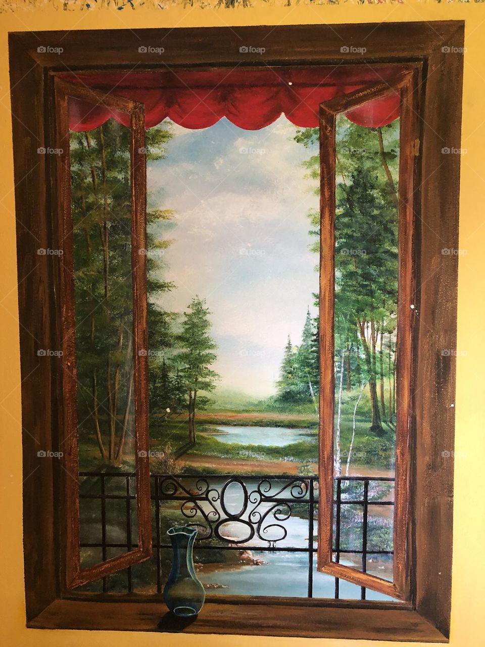 Mural of window with peaceful lake and forrest scene on a wall