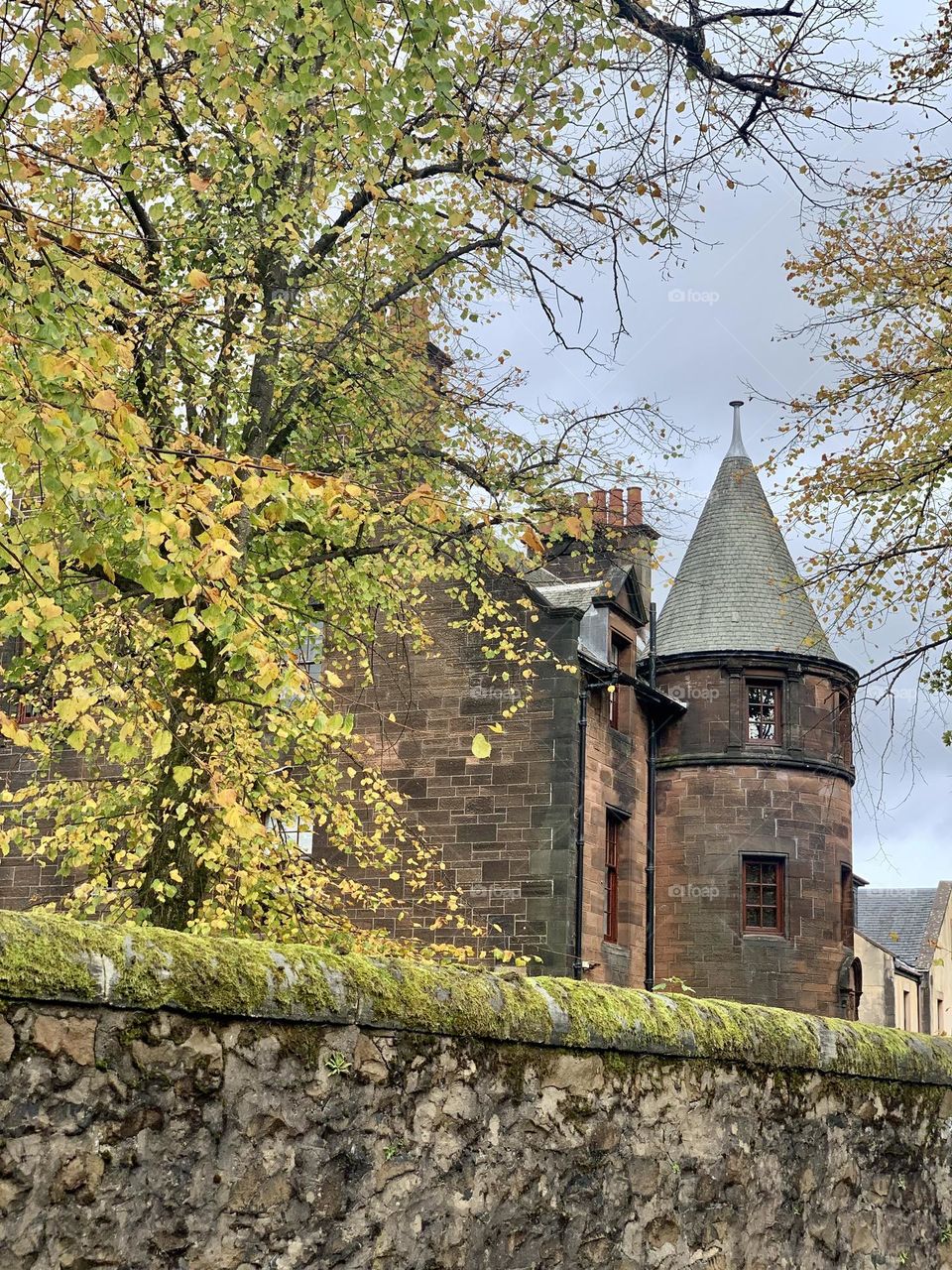 Old house with a tower in the autumn season