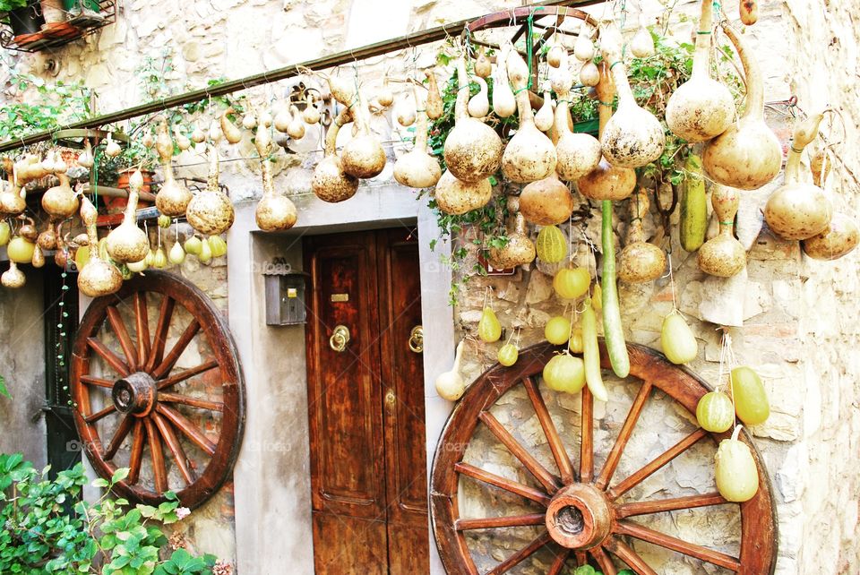 Pumpkins and wheels outside a Tuscan house - Castelnuovo Berardenga, Siena, Italy.