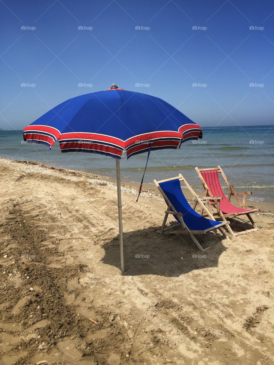 Deck chairs and umbrella on the beach
