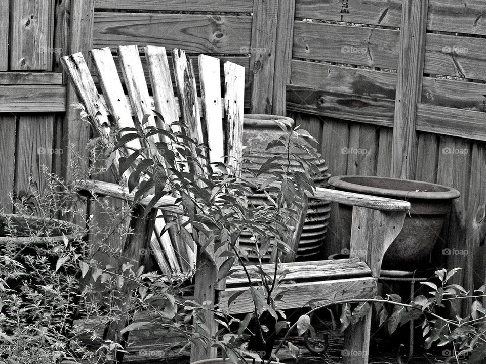 Old Chair. Photo of a wooden chair in the vicinity of a shower house waiting for someone to occupy it!