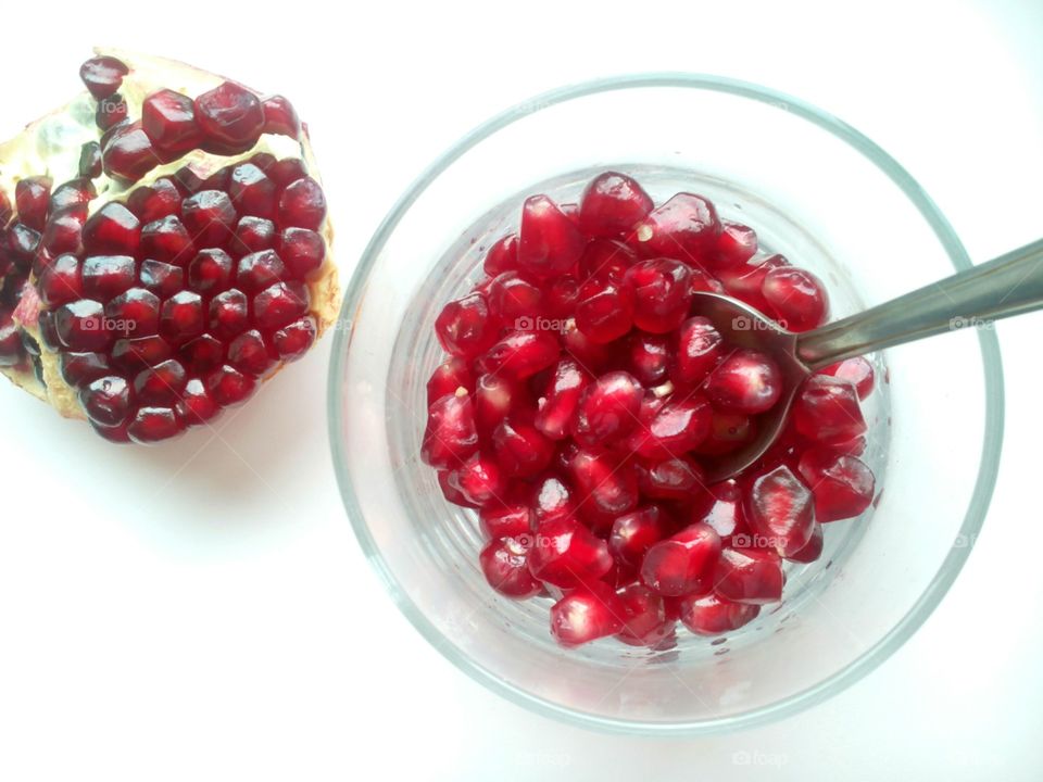 Pomegranate seeds in glass bowl