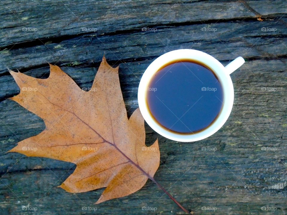 Coffee on the table with a leaf