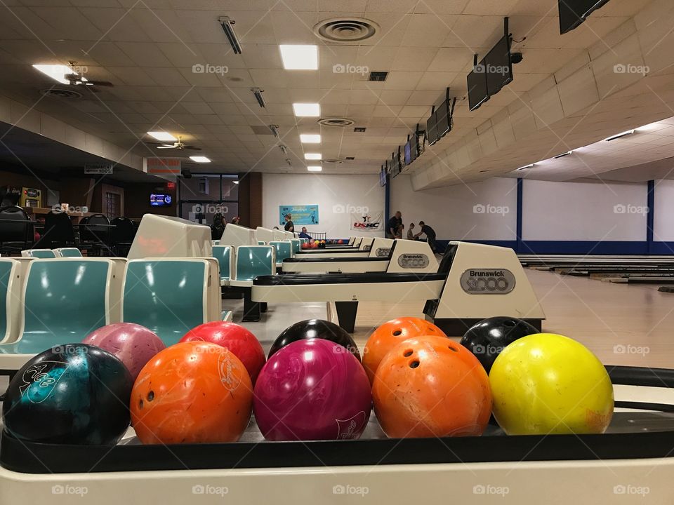 View of colorful balls in bowling alley