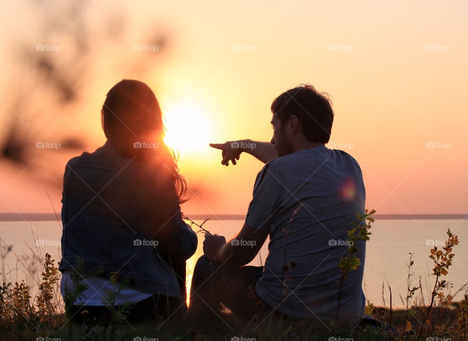 Loving couple watching sunset