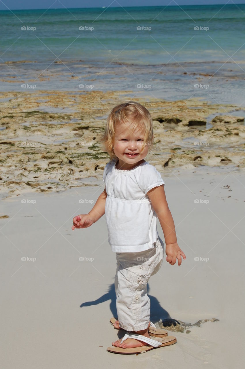 Little girl walking at beach