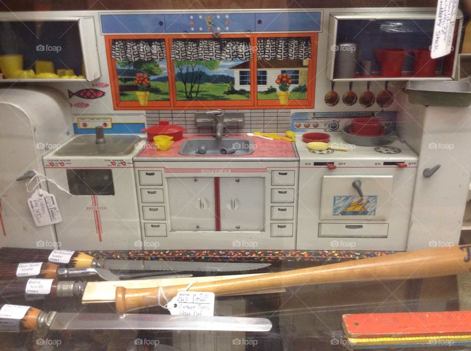 This is a vintage toy kitchen for sale in an antique mall.