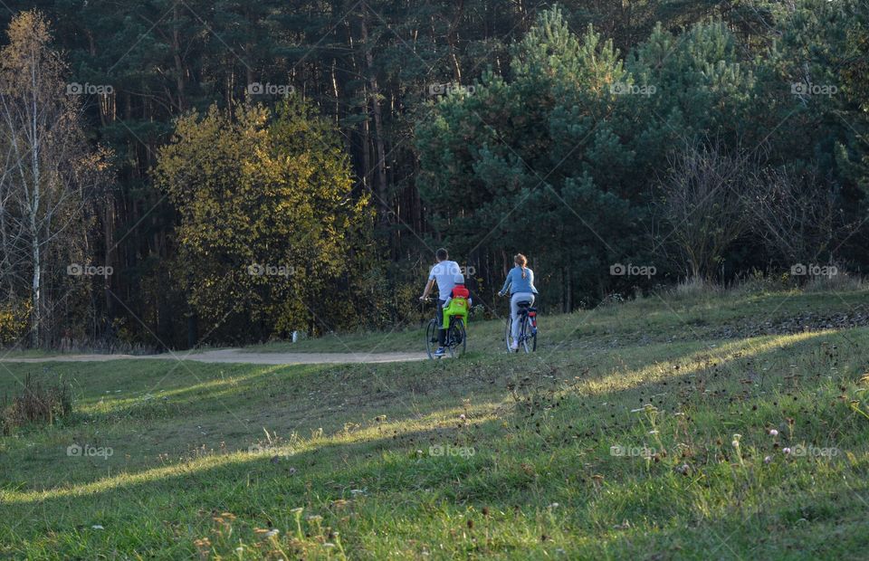 family riding on a bikes countryside