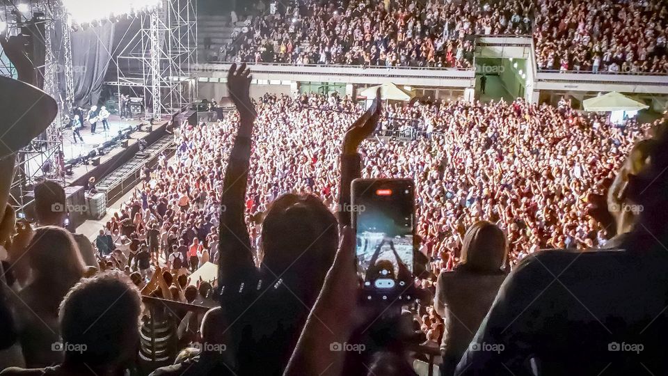 Recording a video of a musical group on the phone at a concert