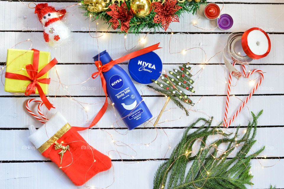 Nivea bodymilk and Nivea creme on Christmas background.