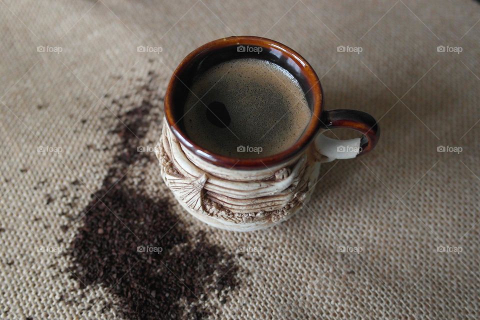 Clay cup of coffee on a burlap napkin 