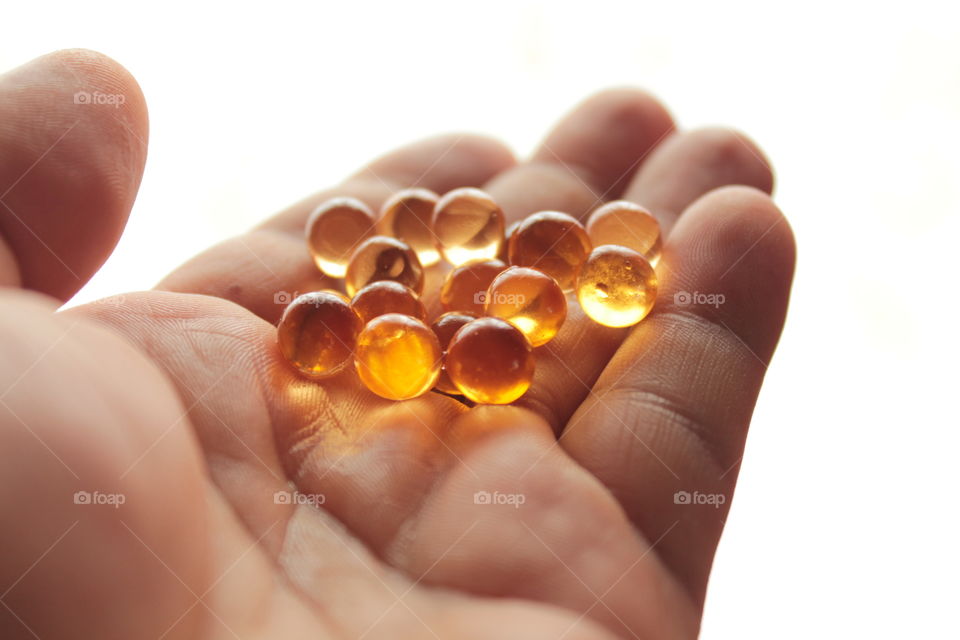 Pills, lights, ice, balls, hand, concrete, pills in hand, beautiful background, glass, round glass, glass balls, LEDs, capsules, bokeh,