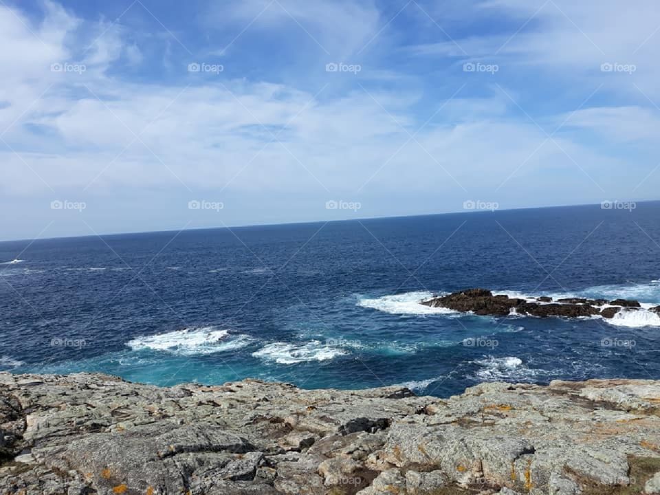 Rocky beach and dark blue water