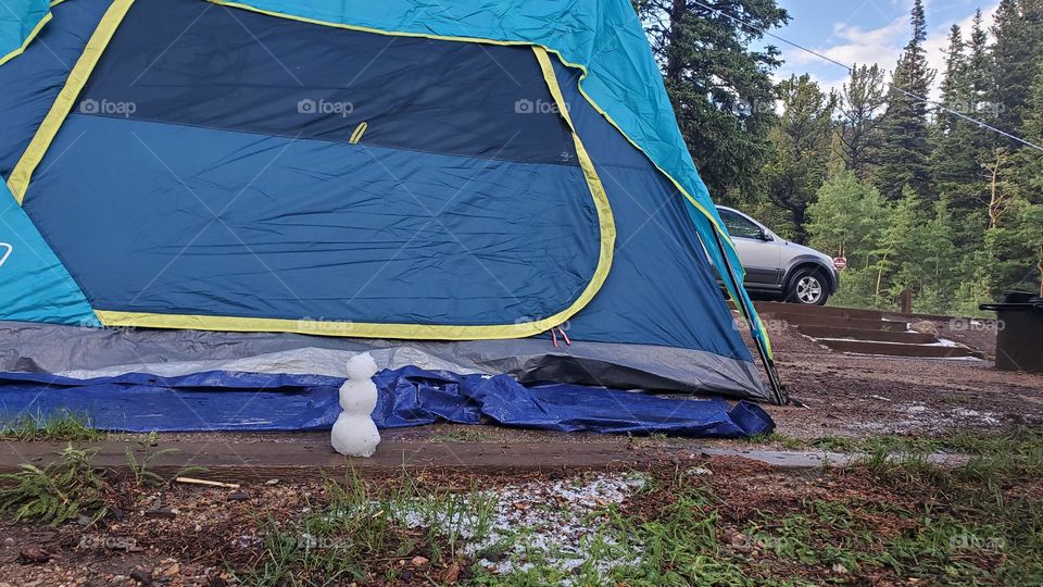 Tiny snowman watching over tent