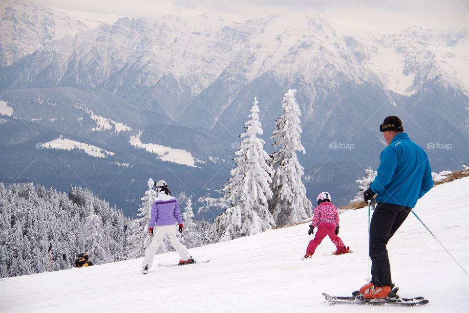 People skiing in peak Postavarul 