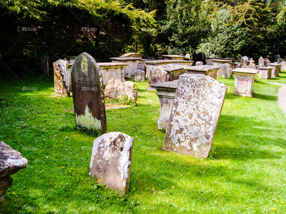 Church graveyard in England with historic tombstones surrounded by green grass