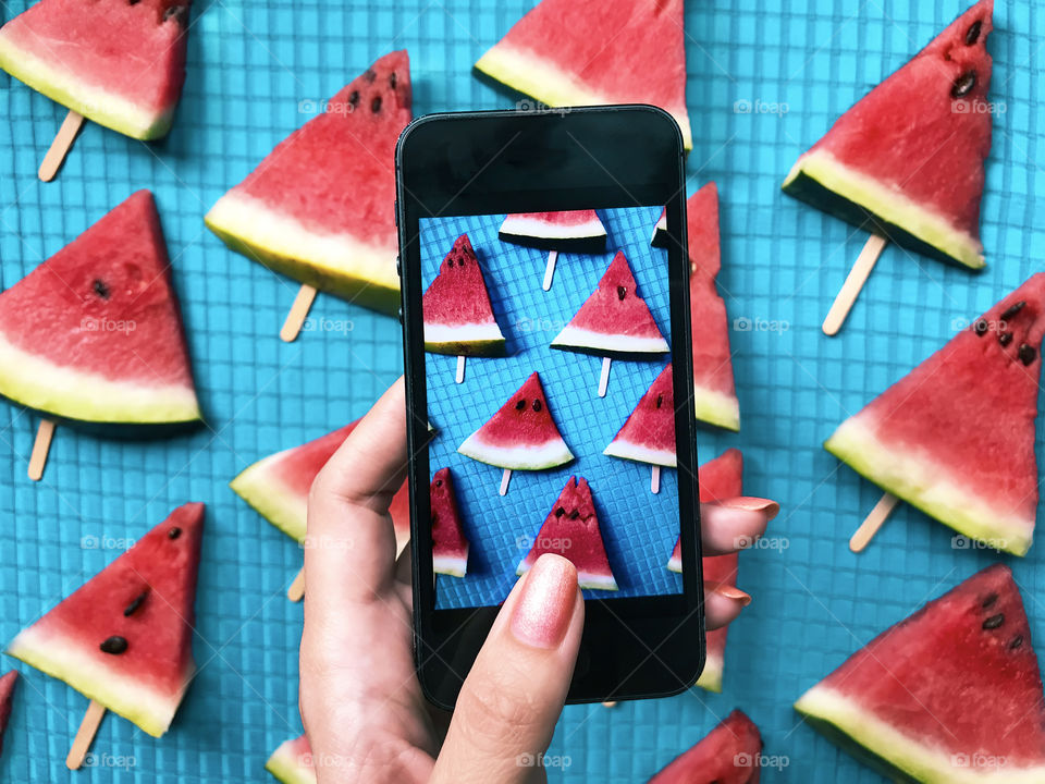 Slices of red watermelon on blue background 