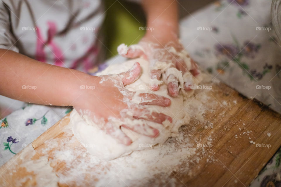 Child while playing with pasta and flour during the quarantine from Covid-19