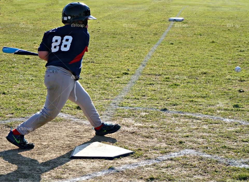 Youth swinging at baseball