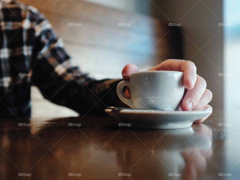 Close-up of person's hand holding coffee mug