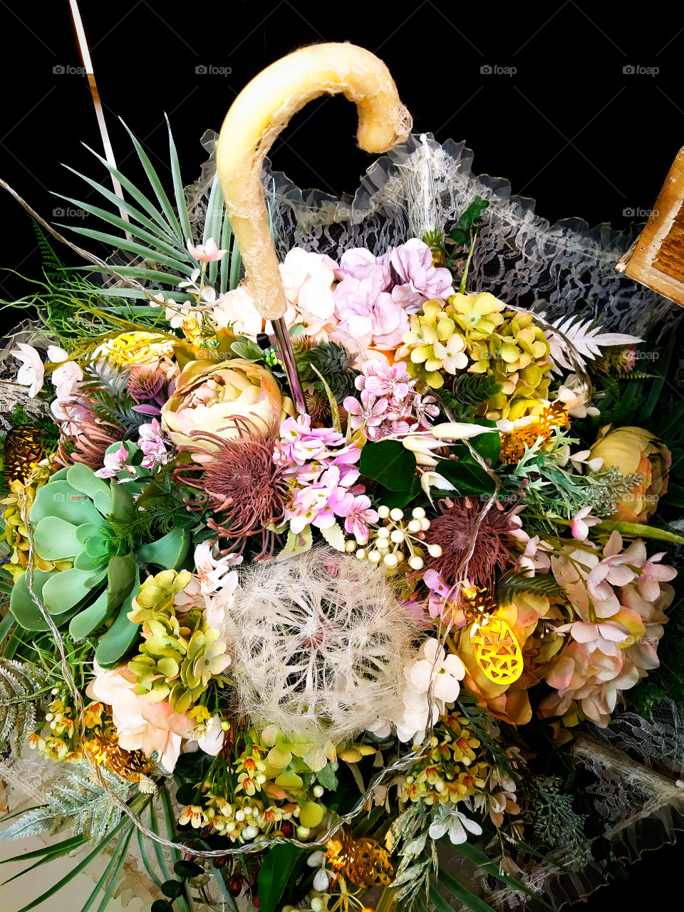 An open umbrella in which a New Year's bouquet of artificial flowers