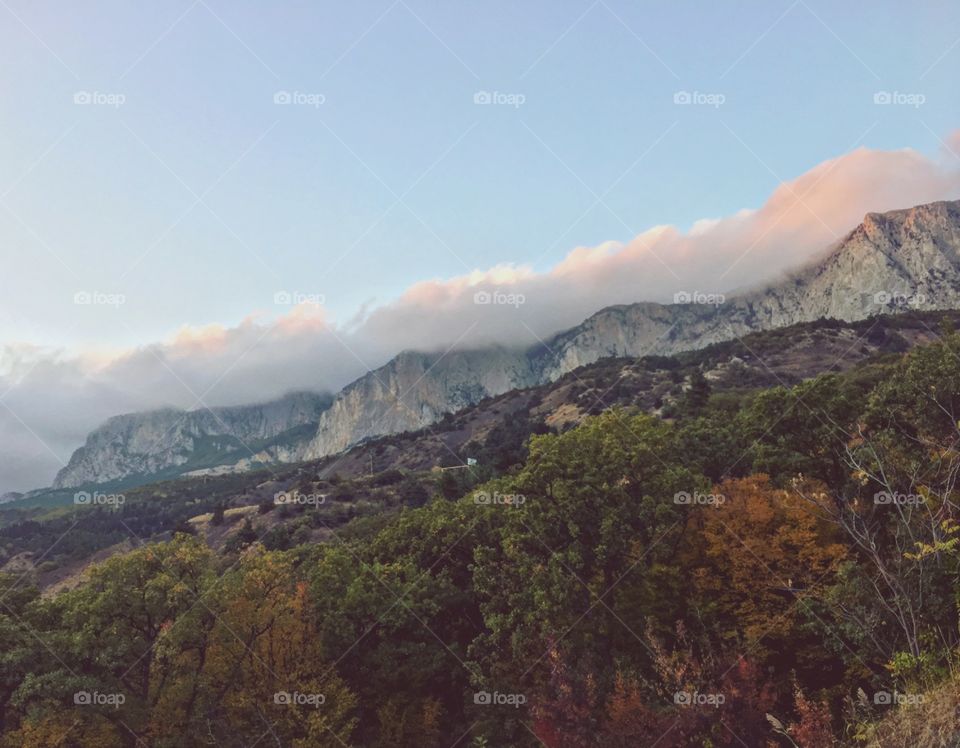 Sunset and clouds above the mountains 