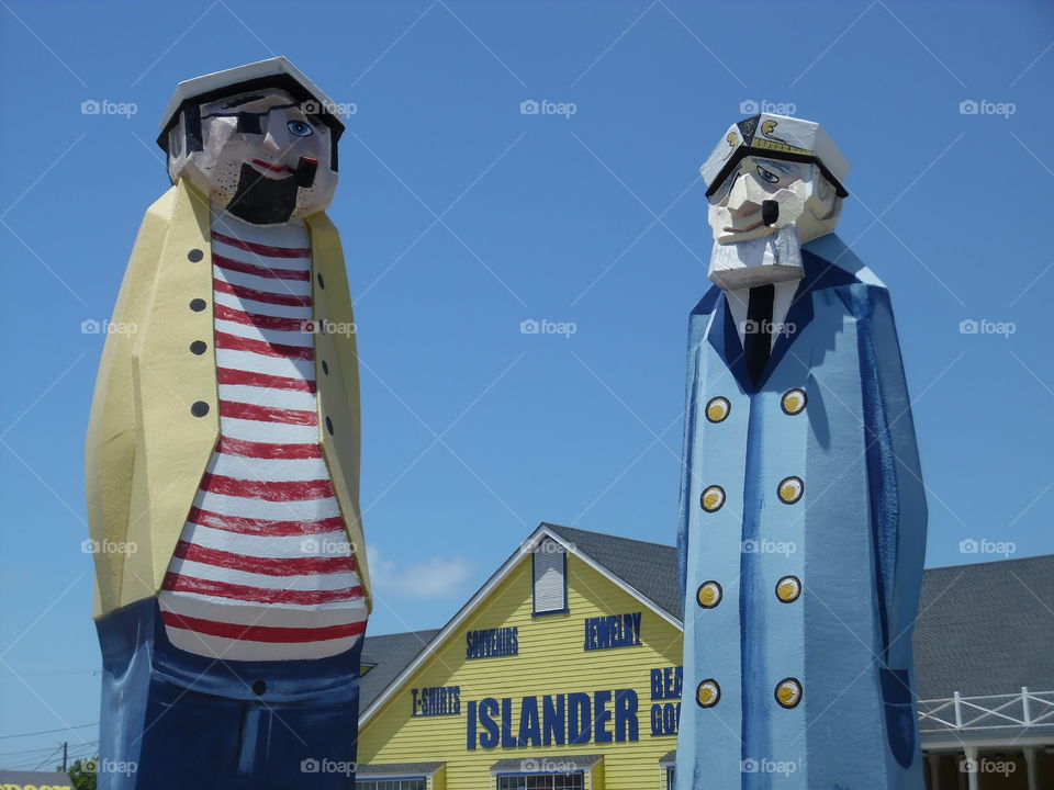 tall cool π ones. This is a picture I took while visiting port Aransas Texas. These figures are standing in front of a restaurant.