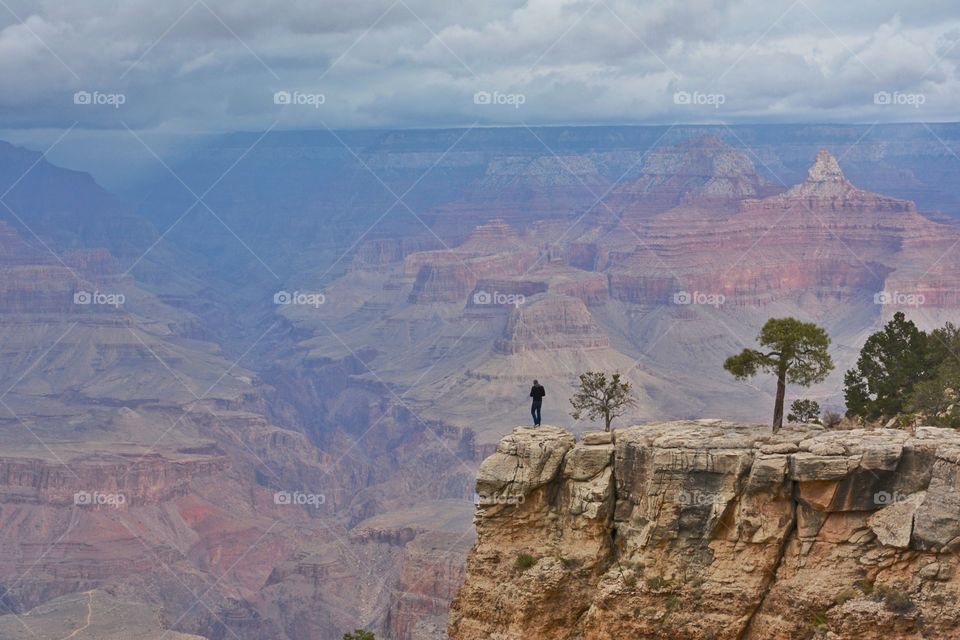 Young man looking over the edge of the Grand Canyon