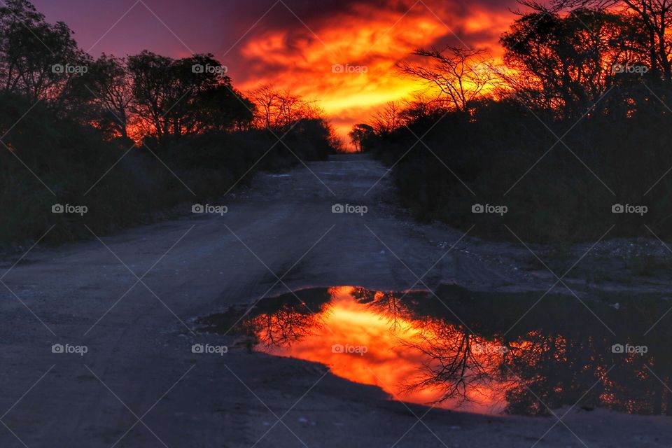 red sky reflected on water
