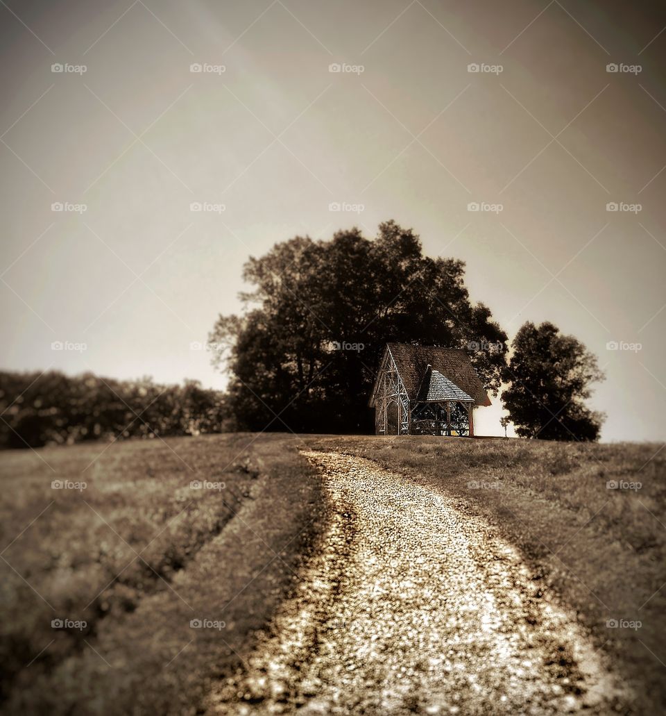 Ancient cottage on a hilltop . An ancient cottage sits atop a hill. 