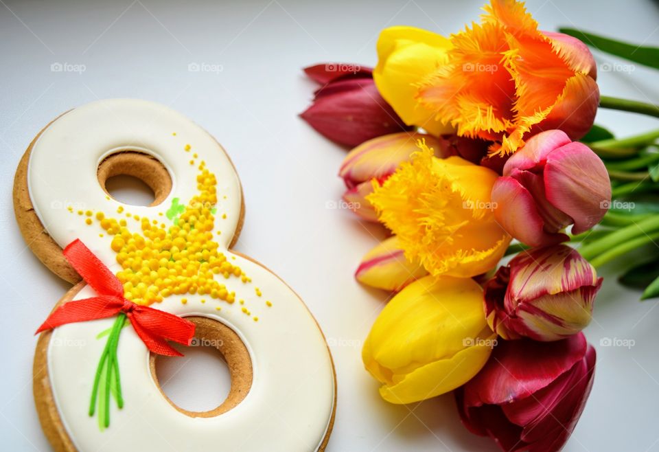 8 March gingerbread and colorful tulips on a white background women's day