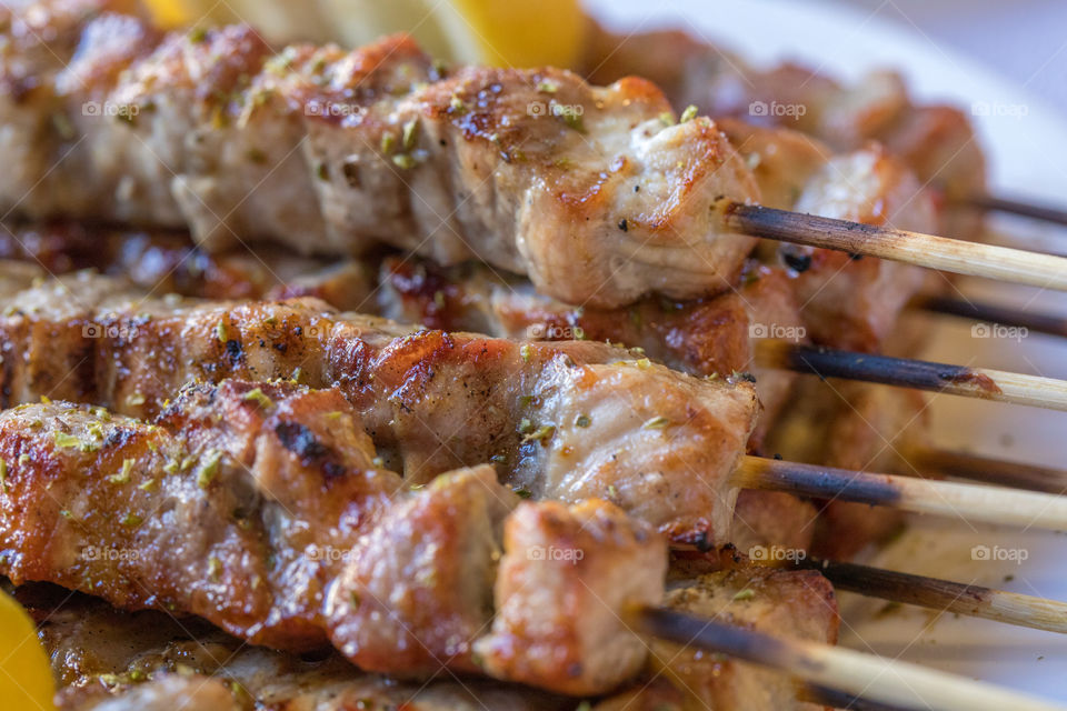 Close up of greek meal ethnic food souvlaki. Roasted meat plate.