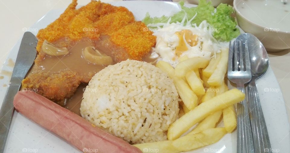 A dinner in a foodcourt. Fried rice with chicken chop!